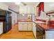 Practical kitchen design with hardwood floors, ample counter space, and white appliances at 1007 Wentworth Dr, Kannapolis, NC 28081
