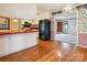 Efficient kitchen layout with red countertops, white cabinets, and hardwood flooring at 1007 Wentworth Dr, Kannapolis, NC 28081