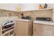 Well-organized laundry room with vintage washer and dryer, plus ample storage shelves at 1007 Wentworth Dr, Kannapolis, NC 28081