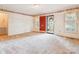 Bright living room featuring a red front door, neutral carpet, and classic wallpaper border at 1007 Wentworth Dr, Kannapolis, NC 28081