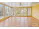 Bright sunroom with large windows, tile flooring, and a ceiling fan at 1007 Wentworth Dr, Kannapolis, NC 28081