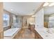 Bright bathroom features a soaking tub, glass shower, tiled floors, and double vanity sinks at 105 Fox Ridge Ln, Mount Holly, NC 28120