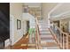 Welcoming foyer with hardwood floors, staircase, and natural light offers an inviting first impression at 105 Fox Ridge Ln, Mount Holly, NC 28120