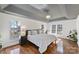 Spacious main bedroom with tray ceiling, hardwood floors, and natural light at 105 Fox Ridge Ln, Mount Holly, NC 28120