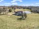 Aerial view of a charming country home nestled on acreage with a picturesque pond at 107 Sunderland Dr, Shelby, NC 28150