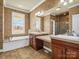 The spacious bathroom features a soaking tub, separate vanities, and wallpaper at 107 Sunderland Dr, Shelby, NC 28150