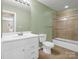 Bathroom with a shower-tub combo, light green walls, toilet, and sink with vanity at 107 Sunderland Dr, Shelby, NC 28150