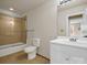 Bathroom with a shower-tub combo, neutral tile, toilet, and sink with vanity at 107 Sunderland Dr, Shelby, NC 28150