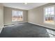 Bright bedroom with carpeted floors and lots of natural light from two large windows at 107 Sunderland Dr, Shelby, NC 28150