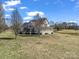 Charming two-story home with a screened porch, situated on a sprawling lot next to a serene pond, surrounded by trees at 107 Sunderland Dr, Shelby, NC 28150