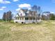 Beautiful two-story home featuring a spacious wrap-around porch, set on a large lot with mature trees and a lush green lawn at 107 Sunderland Dr, Shelby, NC 28150