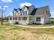 Charming two-story home featuring a welcoming front porch and an attached garage, set on a lush green lawn under a blue sky at 107 Sunderland Dr, Shelby, NC 28150