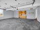 Spacious garage with a concrete floor, blue walls, and wooden cabinets at 107 Sunderland Dr, Shelby, NC 28150