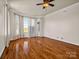 Spacious living room featuring hardwood floors, large windows, neutral walls, and a ceiling fan at 107 Sunderland Dr, Shelby, NC 28150