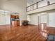 Open concept living room showing hardwood floors and a view into the kitchen and second story landing at 107 Sunderland Dr, Shelby, NC 28150