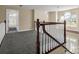 Second story landing showcasing the open space with carpet floors and wooden railings at 107 Sunderland Dr, Shelby, NC 28150