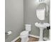 Powder room featuring a pedestal sink, toilet, and modern fixtures at 107 Sunderland Dr, Shelby, NC 28150