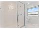 Modern bathroom features a glass-enclosed shower and a window with natural light at 1133 Metropolitan Ave # 310, Charlotte, NC 28204