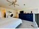 Bright bedroom has a workstation, modern ceiling fan, and stylish blue storage lockers at 1133 Metropolitan Ave # 310, Charlotte, NC 28204