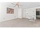 Bright and airy bedroom with a ceiling fan, neutral carpet, and access to an attached bath and closet at 1133 Metropolitan Ave # 310, Charlotte, NC 28204