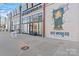 Street-level brewery and restaurant with large storefront windows and colorful wall art at 1133 Metropolitan Ave # 310, Charlotte, NC 28204