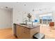 Open kitchen includes an island bar with granite countertops and leads into the living area at 1133 Metropolitan Ave # 310, Charlotte, NC 28204
