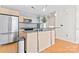 Modern kitchen featuring stainless steel appliances, granite countertops, a stylish island, and hardwood floors at 1133 Metropolitan Ave # 310, Charlotte, NC 28204