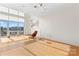 A spacious and open living room with bright natural light has a floor lamp with a chair and ottoman at 1133 Metropolitan Ave # 310, Charlotte, NC 28204