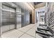 Modern lobby area featuring sleek tile floors, seating, and stainless steel elevators at 1133 Metropolitan Ave # 310, Charlotte, NC 28204