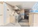 A stainless steel outdoor kitchen area includes a grill and ventilation hood against a brick wall at 1133 Metropolitan Ave # 310, Charlotte, NC 28204