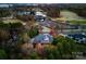 Aerial view of a luxury home, golf course, lake and surrounding neighborhood at 131 The Point Dr, Mooresville, NC 28117
