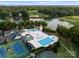 Beautiful aerial view of tennis courts, pools, and clubhouse situated alongside the lake and golf course at 131 The Point Dr, Mooresville, NC 28117