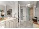 Bright bathroom featuring dual vanities, marble countertops, a soaking tub, and a glass-enclosed shower at 131 The Point Dr, Mooresville, NC 28117