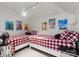 Bright bedroom with white plank walls, two twin beds, and colorful vintage travel posters at 131 The Point Dr, Mooresville, NC 28117