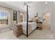 Well-lit bedroom offers a comfortable bed and ample natural light, creating a peaceful and inviting atmosphere at 131 The Point Dr, Mooresville, NC 28117