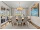 Elegant dining room with large windows, chandelier, and seating for eight, perfect for gatherings at 131 The Point Dr, Mooresville, NC 28117