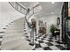 Beautiful foyer with a curved staircase and black and white checkered floors at 131 The Point Dr, Mooresville, NC 28117