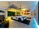 Spacious garage featuring a sleek white sports car and a golf cart, showcasing ample space for vehicles and storage at 131 The Point Dr, Mooresville, NC 28117