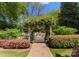 Charming garden gate adorned with climbing plants, offering a picturesque entrance to a private outdoor area at 131 The Point Dr, Mooresville, NC 28117
