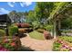 Beautiful garden path featuring lush landscaping and brick pavers, creating a serene and inviting outdoor space at 131 The Point Dr, Mooresville, NC 28117