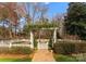 Beautiful garden with white picket fences, brick pathways, and lush landscaping at 131 The Point Dr, Mooresville, NC 28117