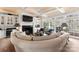 Inviting living room boasts a fireplace, coffered ceiling, and access to the outdoor space through large glass doors at 131 The Point Dr, Mooresville, NC 28117