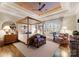Serene main bedroom features a four-poster bed, decorative ceiling, and ample natural light at 131 The Point Dr, Mooresville, NC 28117