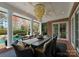 Outdoor patio area with a large dining table, chandelier, and a view of the pool at 131 The Point Dr, Mooresville, NC 28117