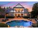 Resort-style backyard with a sparkling pool and outdoor dining area at 131 The Point Dr, Mooresville, NC 28117