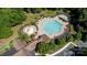 Stunning aerial view of the community pool and clubhouse nestled among mature trees and landscaping at 13215 Claysparrow Rd, Charlotte, NC 28278