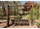 Scenic backyard features a wooden swing set near a peaceful pond surrounded by mature trees and lush greenery at 13215 Claysparrow Rd, Charlotte, NC 28278