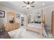 Cozy bedroom showcasing a four-poster bed and a wooden dresser at 13215 Claysparrow Rd, Charlotte, NC 28278