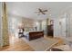 Tranquil bedroom with hardwood floors, ceiling fan, and elegant furnishings at 13215 Claysparrow Rd, Charlotte, NC 28278