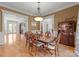 Formal dining room featuring hardwood floors, chandelier, and traditional wood furniture at 13215 Claysparrow Rd, Charlotte, NC 28278